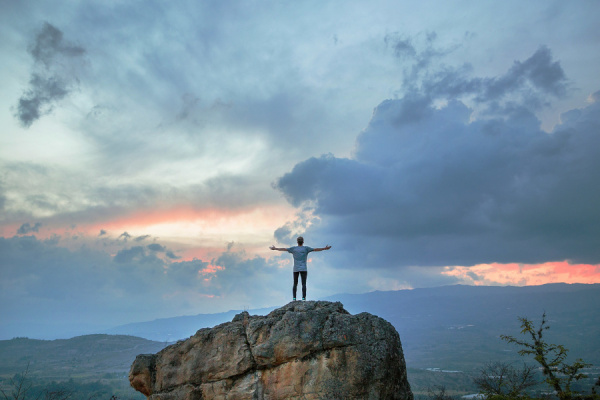 person standing on mountain top image